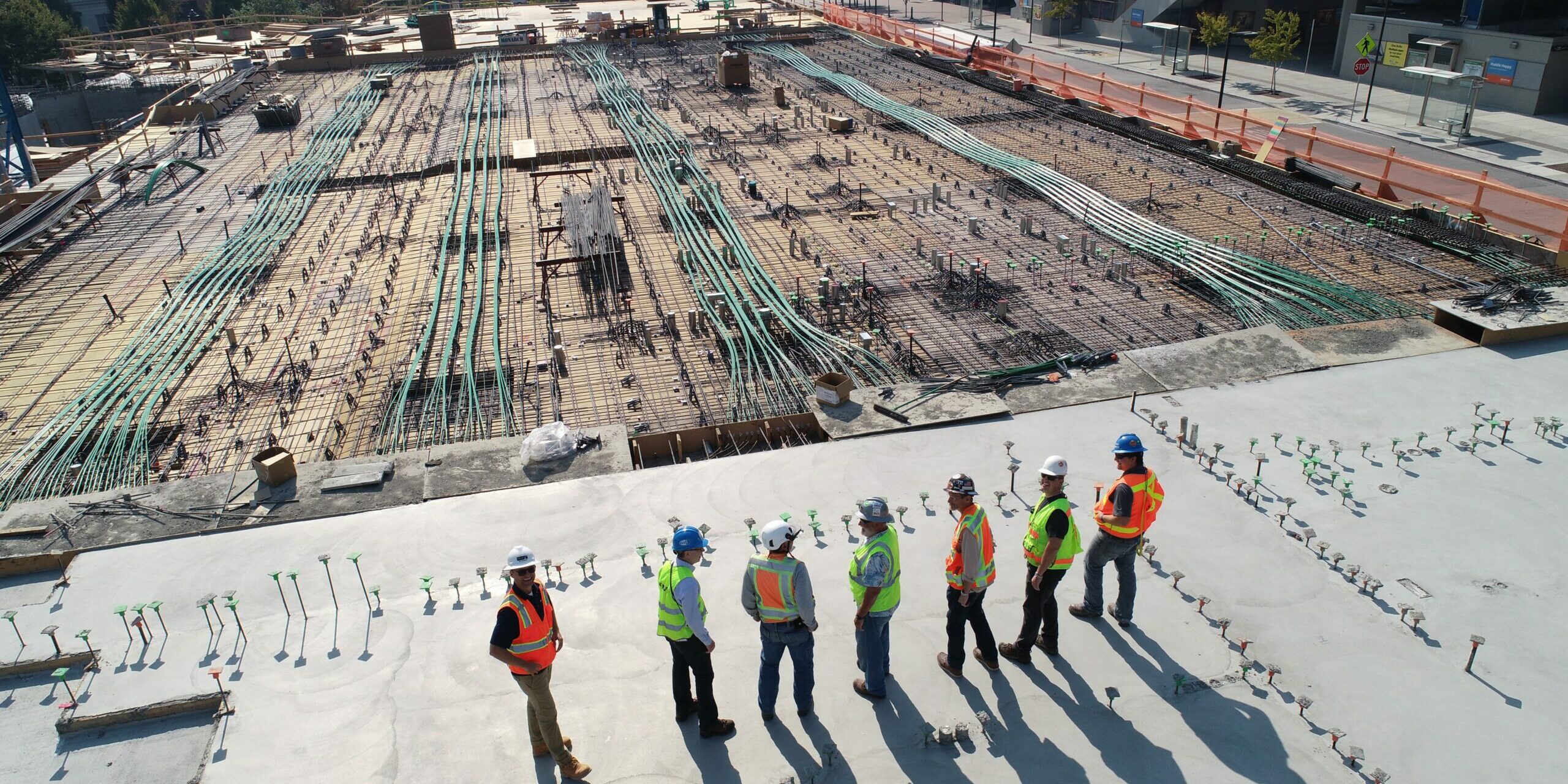 Engineering in summer People standing next to a construction site