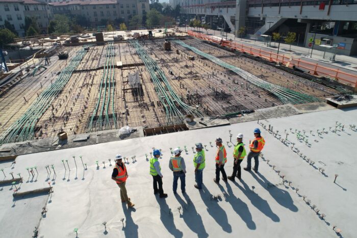 People standing next to a construction site