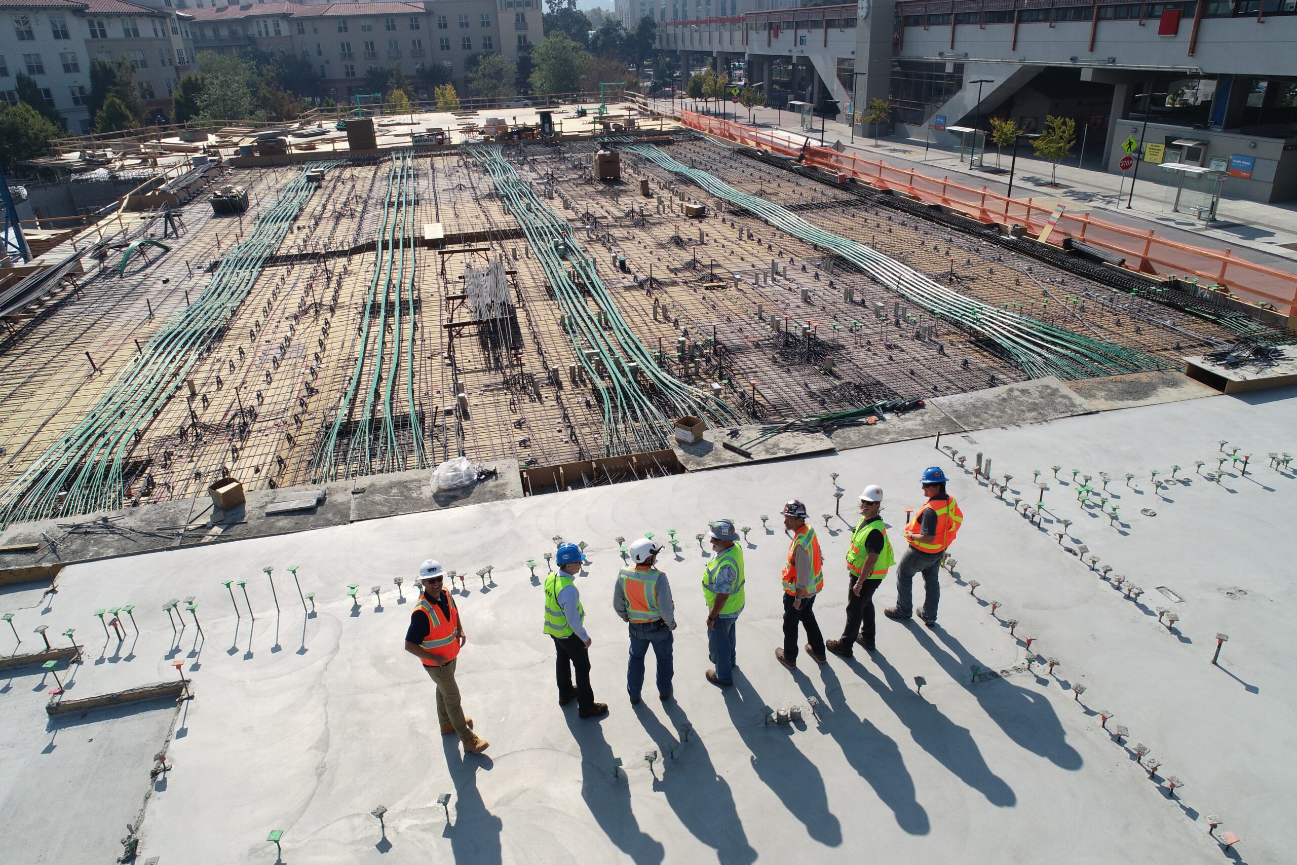 People standing next to a construction site